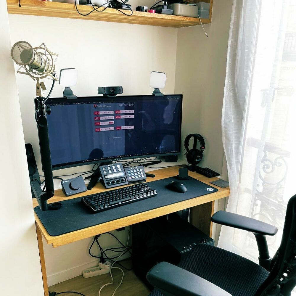 Setup de NotPatrick logé dans une alcôve : écran ultrawide, micro sur bras, clavier TKL, casque