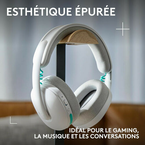 Casque audio sans fil blanc avec des détails turquoise, présenté sur un support. Il est conçu pour le gaming, la musique et les conversations.
