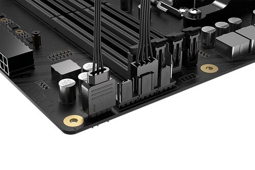 Gros plan sur les connecteurs de câbles internes d'une carte mère noire, montrant les ports de branchement pour les composants du PC.