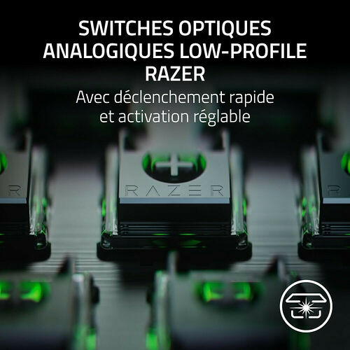 Des switches optiques analogiques low-profile de la marque Razer, avec un éclairage vert, présentés en gros plan.