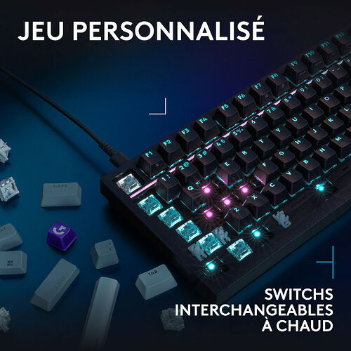 Clavier mécanique compact avec touches rétroéclairées et switches interchangeables à chaud, présenté avec des touches détachées autour.