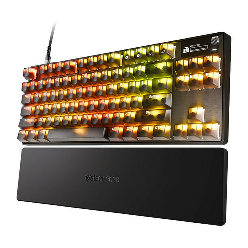 Clavier mécanique SteelSeries avec rétroéclairage RGB coloré et repose-poignet noir assorti.