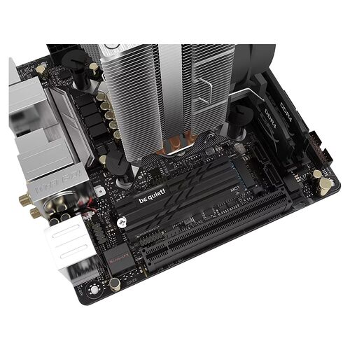 Carte mère noire avec un ventirad argenté imposant, des emplacements pour mémoire DDR4 et des ports d'extension PCIe.