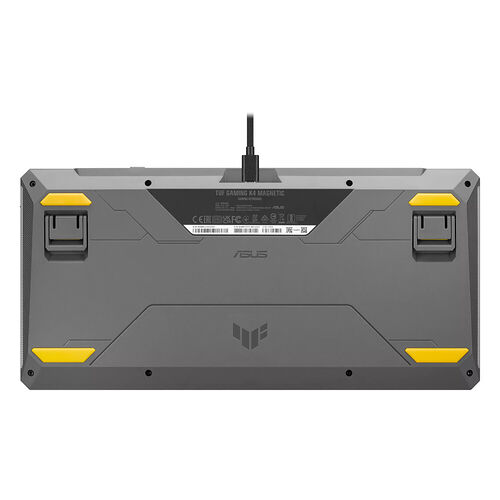 L'arrière d'un clavier gaming ASUS TUF Gaming K4 Magnetic, montrant ses pieds en caoutchouc jaune et son câble USB noir.