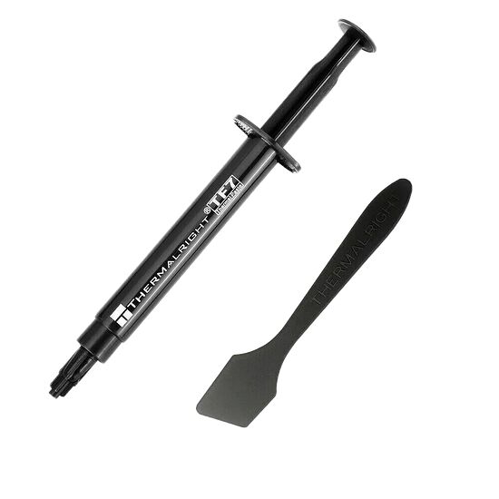 Une seringue de pâte thermique Thermalright TF9 accompagnée d'une spatule de l'même marque pour une application précise.