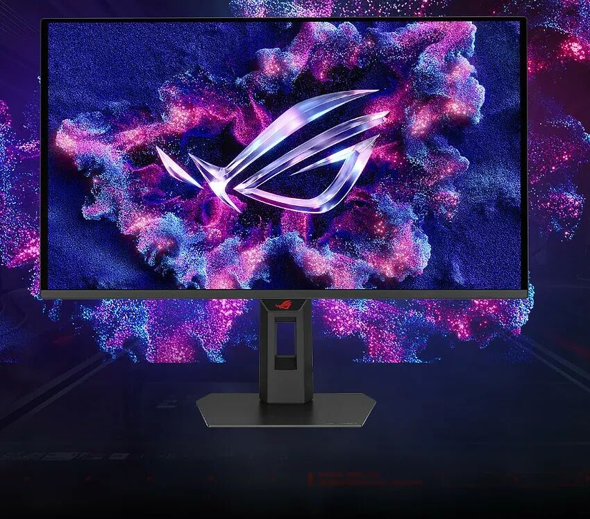 Écran de PC gamer ASUS ROG avec un fond d'écran abstrait violet et bleu. L'écran affiche le logo ROG au centre.