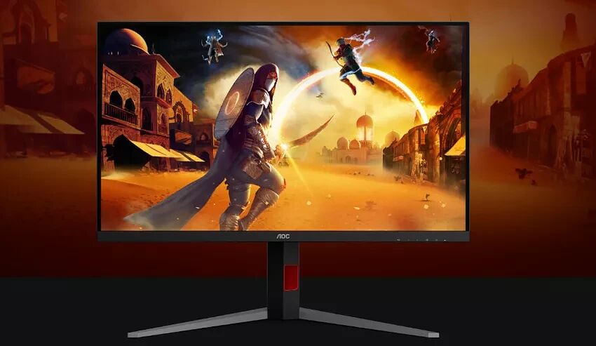 Écran de PC gamer AOC affichant une scène de combat fantastique avec des personnages en pleine action dans un décor désertique.