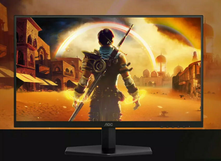 Écran de PC gamer AOC affichant une scène de jeu fantastique avec un personnage de dos face à un arc-en-ciel et une cité ancienne.