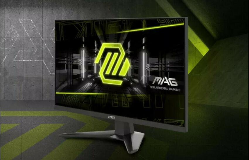 Écran de PC MSI de la gamme MAG, affichant un fond d'écran graphique noir et vert néon. L'écran est présenté sur un pied gris dans un environnement sombre et stylisé.
