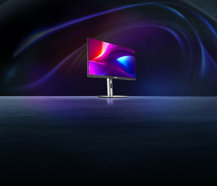 Écran PC ASUS affichant un fond d'écran coloré aux nuances de violet et bleu, présenté sur un pied argenté dans un environnement sombre et stylisé.