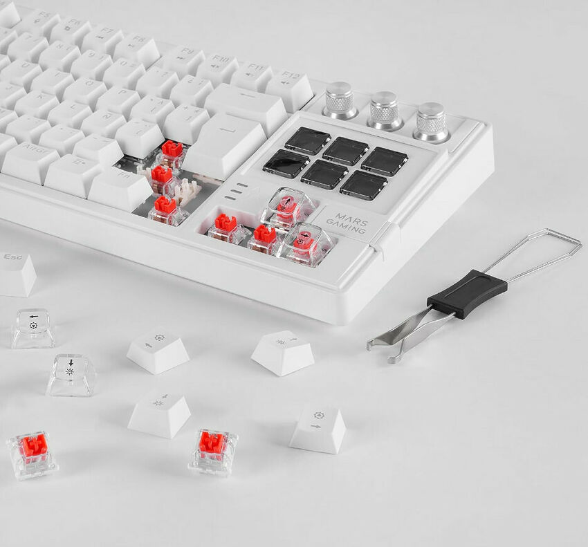 Clavier mécanique blanc de la marque Mars Gaming avec des touches détachables, des switchs rouges et un outil de retrait de touches.