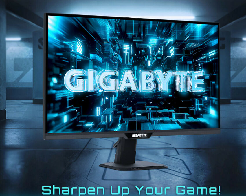 Écran de PC Gamer Gigabyte affichant un fond d'écran numérique bleu et noir avec le logo de la marque au centre.